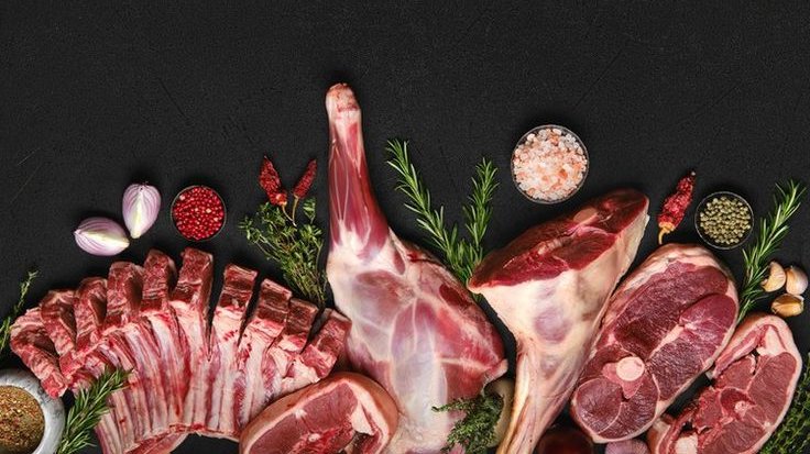 An assortment of fresh, halal-certified cuts of meat with herbs and spices